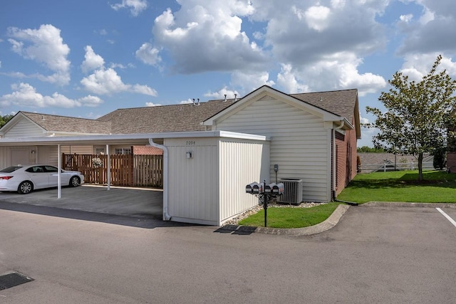 view of home's exterior featuring central AC and a carport