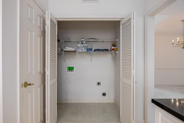 laundry area with electric dryer hookup, washer hookup, and a notable chandelier