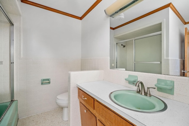 full bath with toilet, a wainscoted wall, speckled floor, crown molding, and vanity