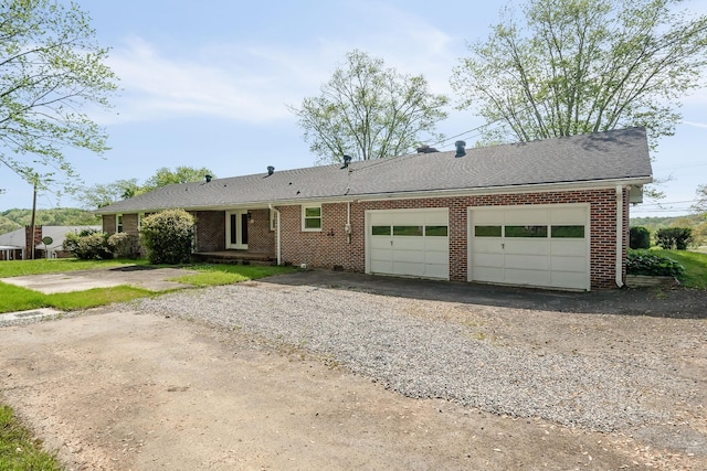 single story home with aphalt driveway, brick siding, a shingled roof, and an attached garage