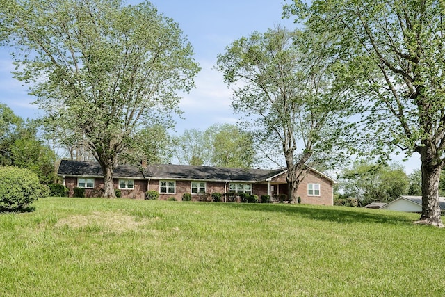 ranch-style house with a front yard and brick siding