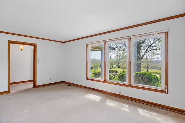 spare room with crown molding and concrete flooring