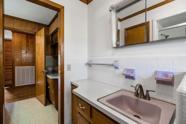 bathroom with vanity, tasteful backsplash, and tile walls