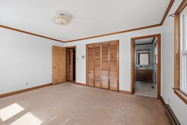 unfurnished bedroom featuring crown molding, a baseboard radiator, and ensuite bathroom