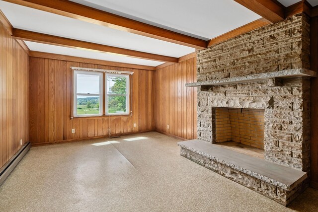 unfurnished living room featuring a baseboard radiator, a fireplace, wooden walls, and beam ceiling