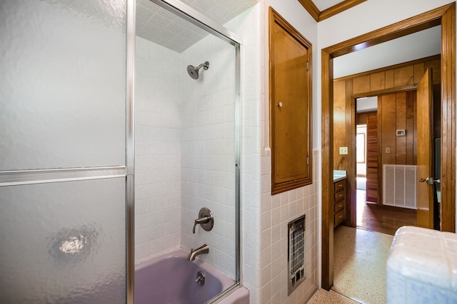 bathroom featuring ornamental molding, vanity, hardwood / wood-style flooring, and enclosed tub / shower combo