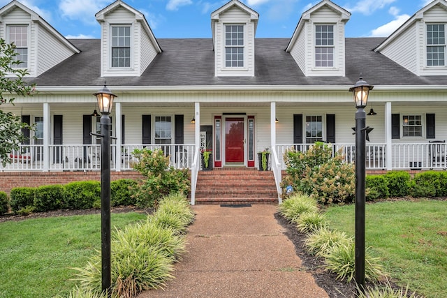 cape cod-style house featuring a front yard and a porch