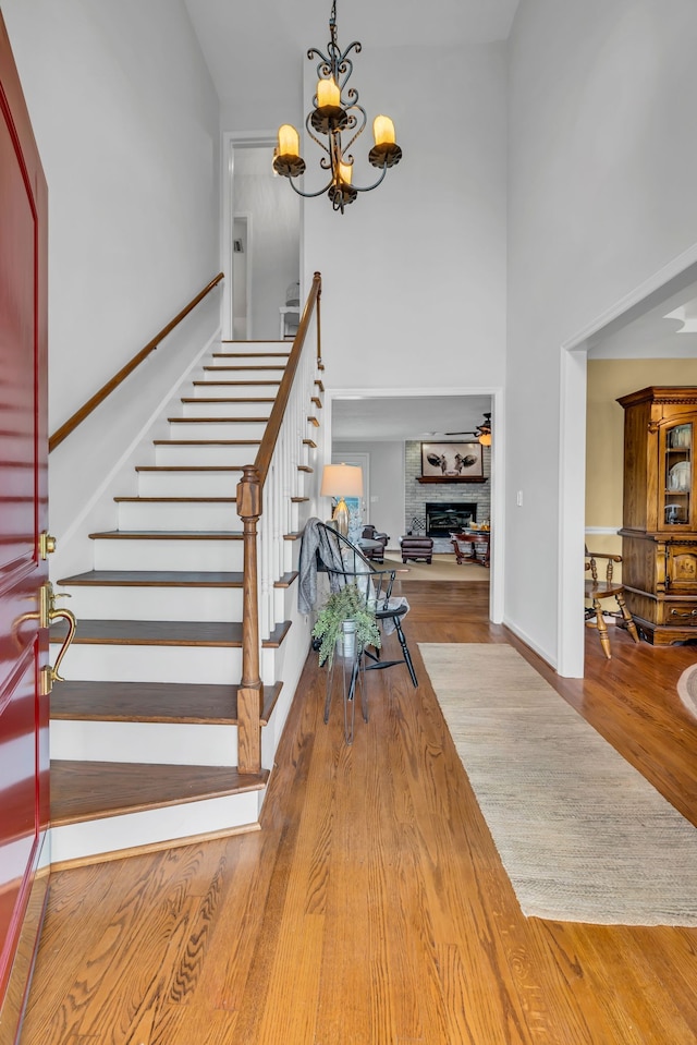 foyer featuring hardwood / wood-style floors, a high ceiling, and an inviting chandelier