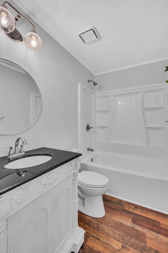 full bathroom featuring hardwood / wood-style flooring, shower / bath combination, vanity, and toilet