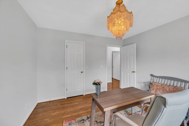 office space with a notable chandelier and hardwood / wood-style floors