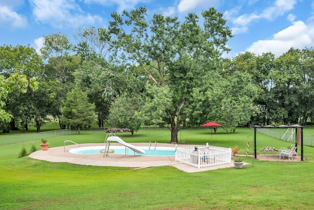 view of property's community featuring a swimming pool and a lawn