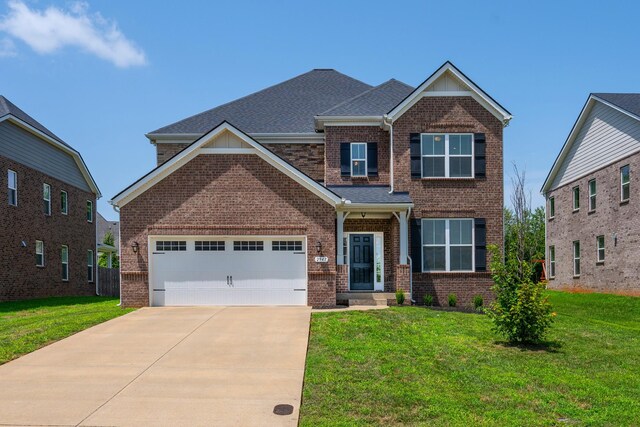 craftsman house featuring a garage and a front yard