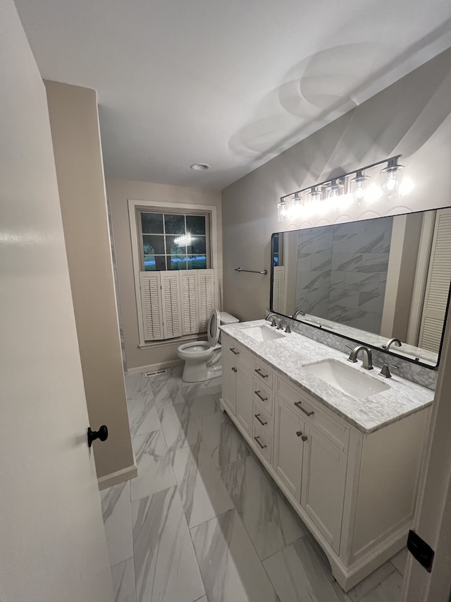 bathroom featuring double vanity, tile patterned flooring, and toilet