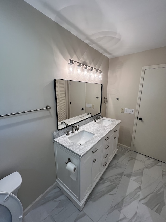 bathroom with toilet, tile patterned floors, and double vanity