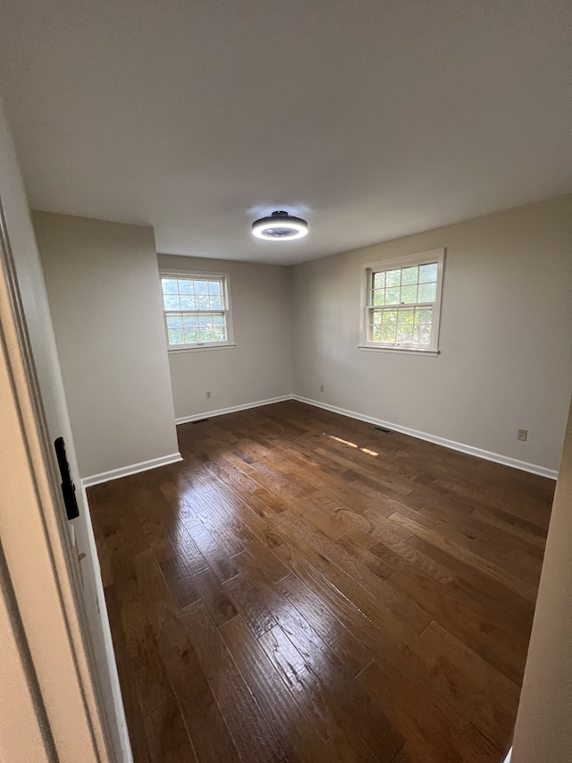 unfurnished room featuring dark hardwood / wood-style floors