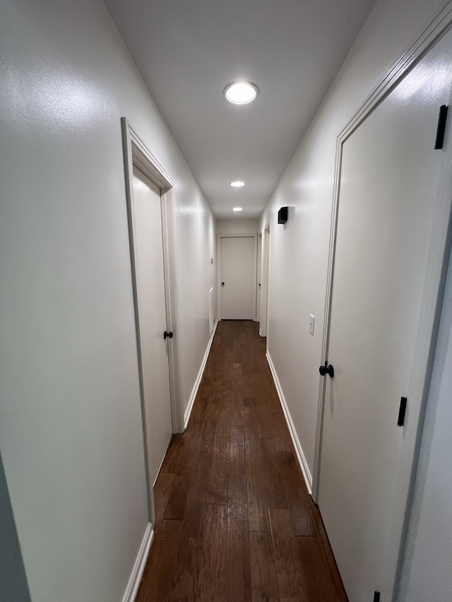 corridor with dark wood-type flooring