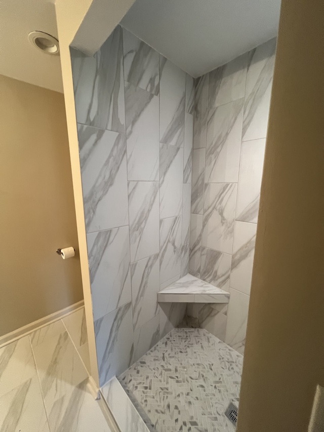 bathroom featuring a tile shower and tile patterned floors