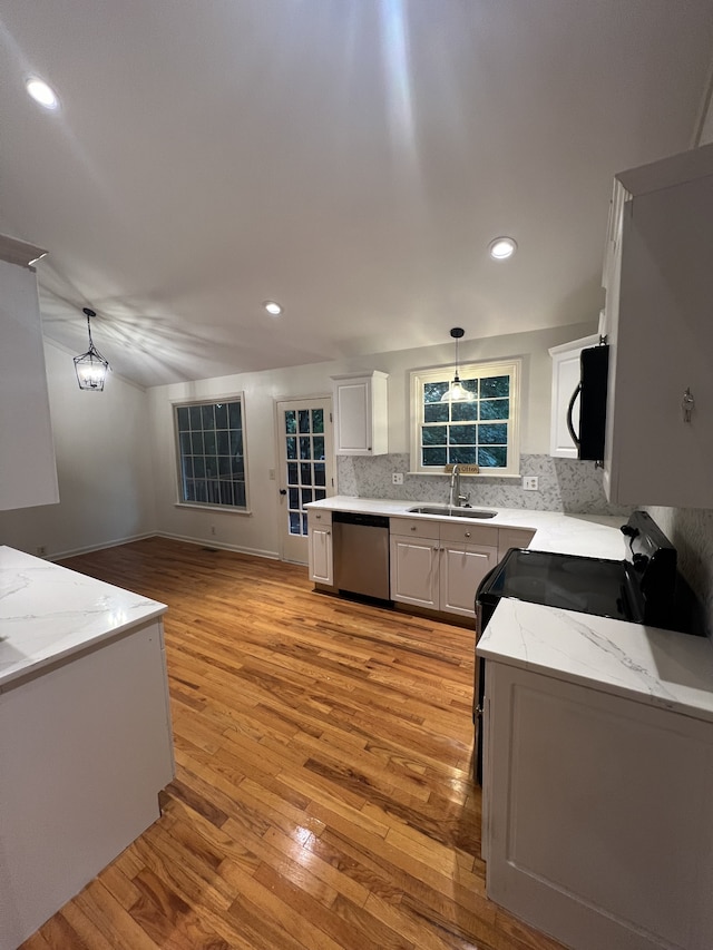 kitchen featuring sink, appliances with stainless steel finishes, light stone counters, and light hardwood / wood-style floors