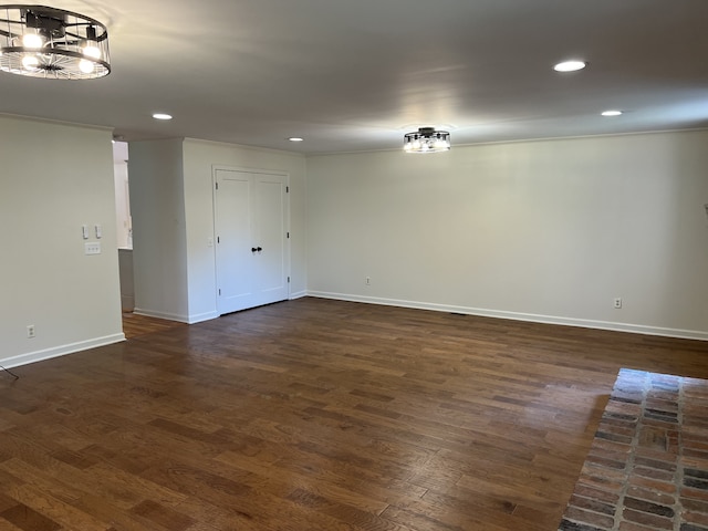 unfurnished room with dark hardwood / wood-style flooring and ornamental molding