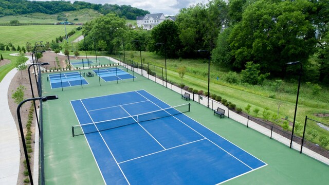 view of tennis court with basketball hoop