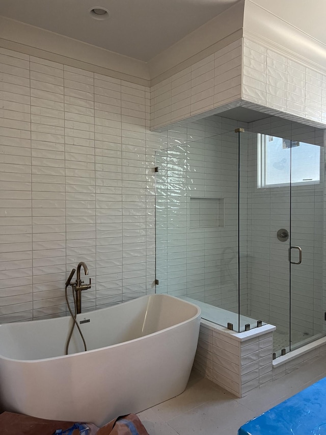 bathroom with tile patterned floors and separate shower and tub