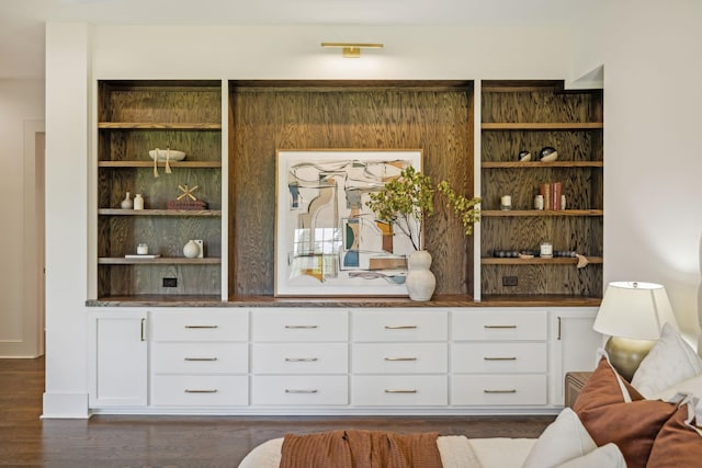 bar featuring dark hardwood / wood-style flooring and white cabinets