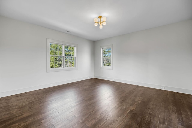 unfurnished room with dark hardwood / wood-style flooring