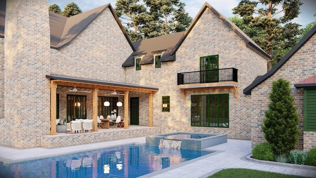 back of property with a swimming pool with hot tub, a patio, and a balcony