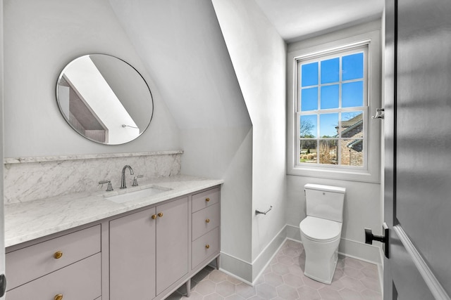 bathroom with tile patterned flooring, vanity, backsplash, and toilet