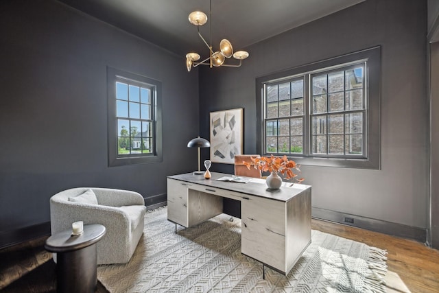 office area featuring an inviting chandelier and light hardwood / wood-style floors