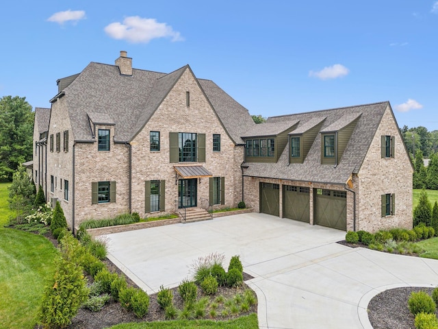 view of front of property featuring a garage and a front yard