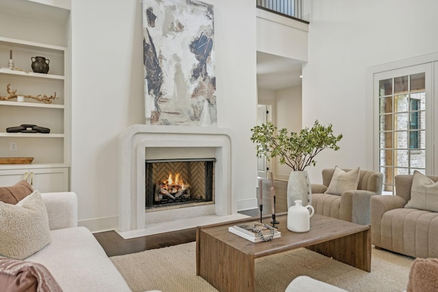 living room featuring hardwood / wood-style floors and built in shelves