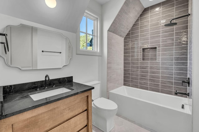 full bathroom featuring tile patterned floors, vanity, toilet, and tiled shower / bath combo