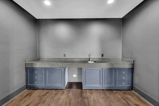 bar featuring dark hardwood / wood-style flooring and sink