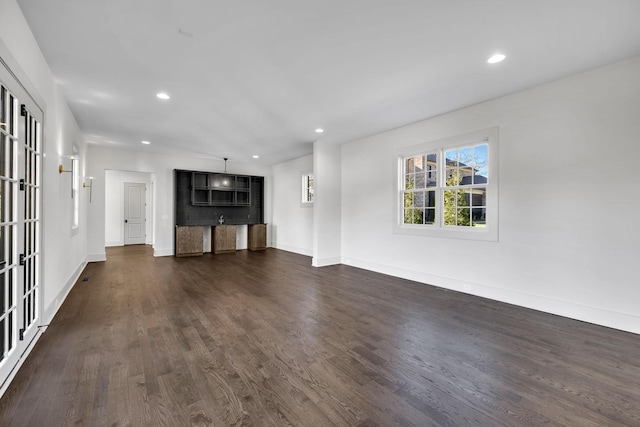 unfurnished living room featuring dark hardwood / wood-style floors