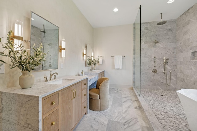 bathroom with a tile shower and vanity