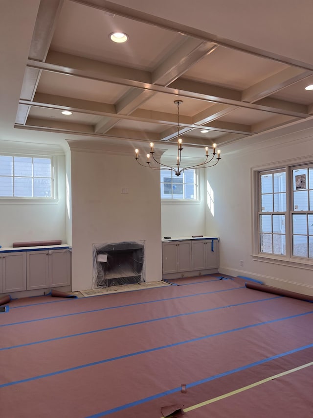 unfurnished living room featuring beamed ceiling, a premium fireplace, and coffered ceiling