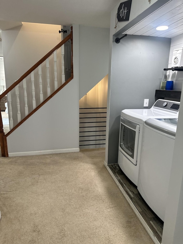 clothes washing area featuring laundry area, separate washer and dryer, and carpet