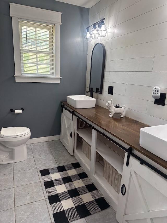 bathroom with vanity, tile patterned flooring, toilet, and baseboards