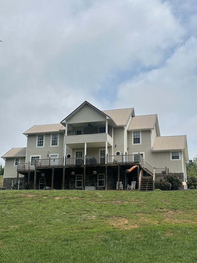 back of house with a lawn, stairway, a ceiling fan, metal roof, and a deck