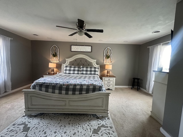 bedroom with visible vents, ceiling fan, light carpet, and baseboards