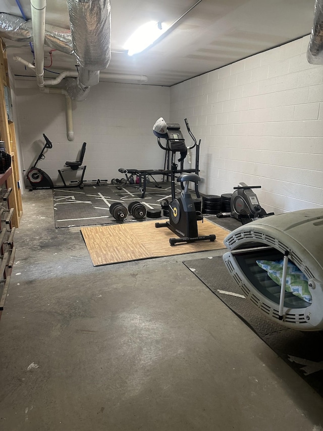 workout area with concrete block wall