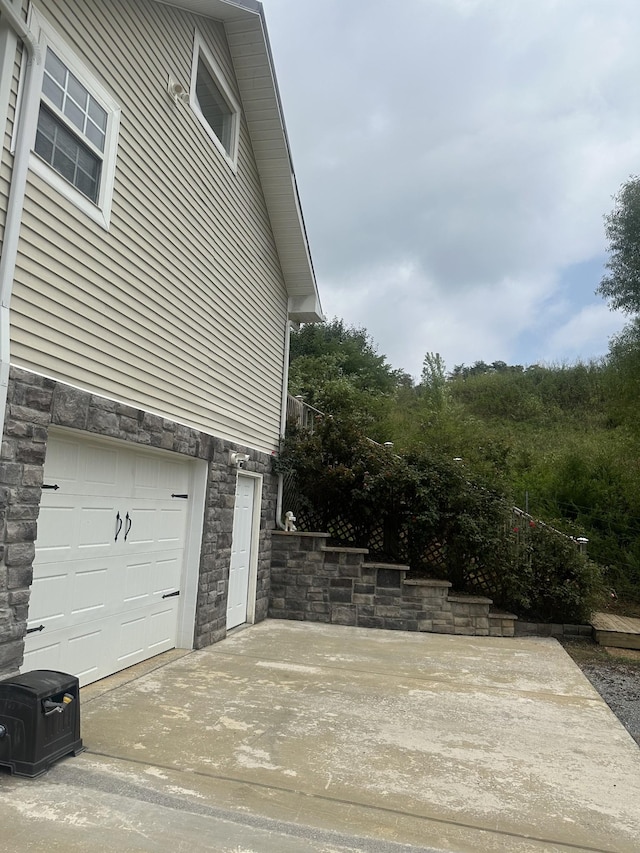 view of side of home featuring stone siding