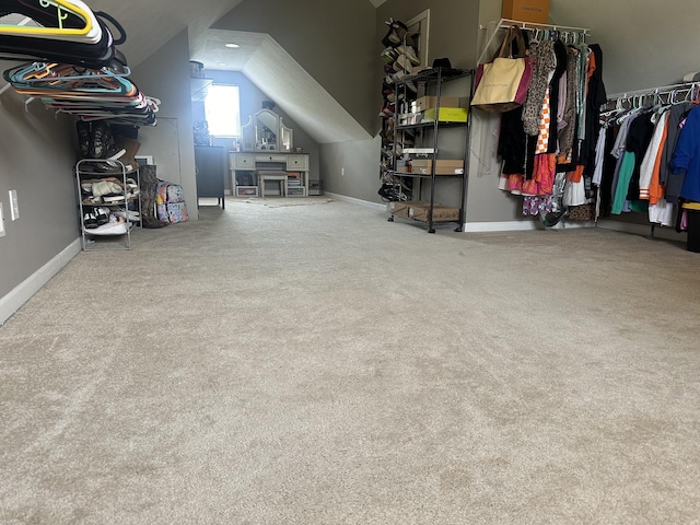 additional living space featuring carpet floors, baseboards, and lofted ceiling