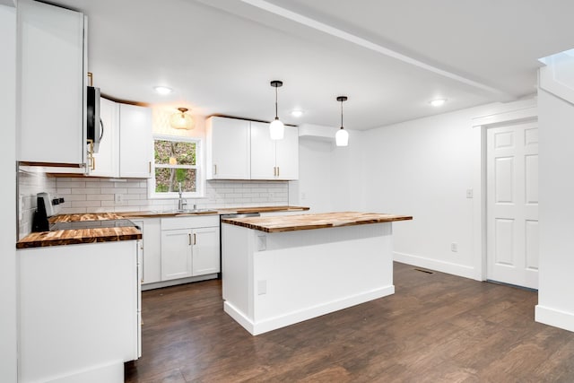 kitchen with wooden counters, range, white cabinetry, hanging light fixtures, and a kitchen island