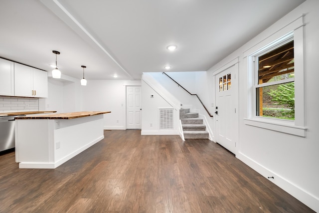 unfurnished living room featuring dark hardwood / wood-style floors