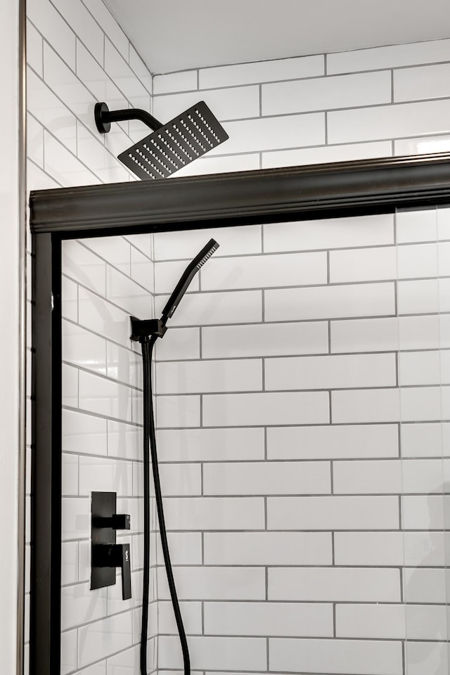 interior details featuring a tile shower