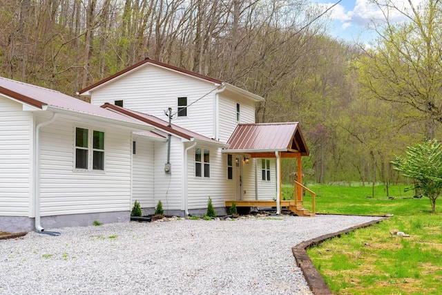 back of property featuring a lawn