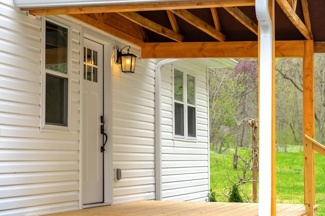 view of exterior entry featuring a wooden deck