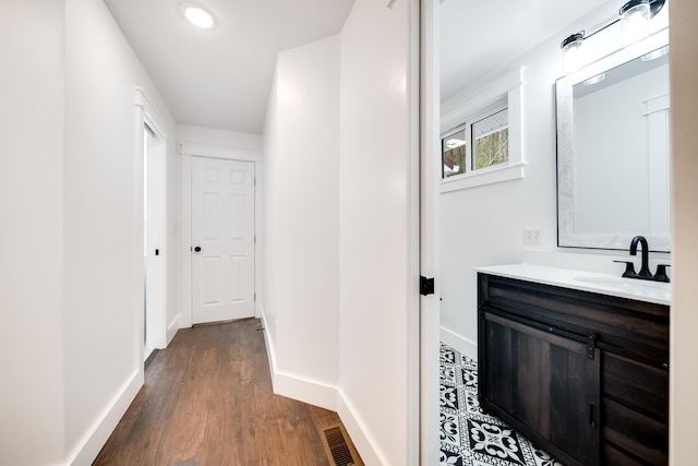 hallway featuring dark hardwood / wood-style floors and sink